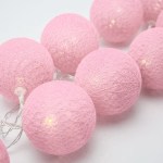 20 ball pastel pink 3m string light battery box 5cm cotton ball christmas birthday bbay girl special occasion decoration Pink string lights glowing on white background.