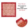 Red organza tablecloth with floral glitter design.