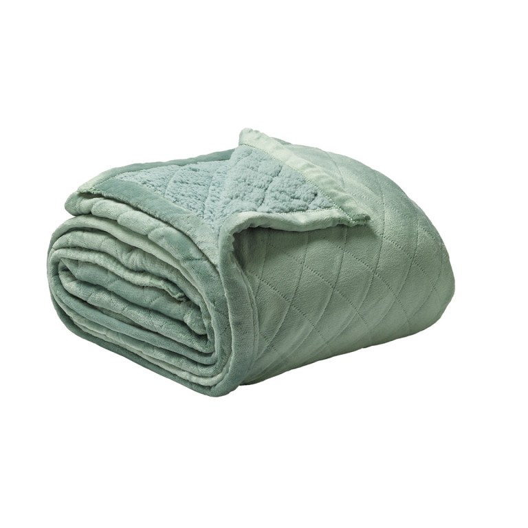 Soft green quilted blanket folded neatly.