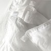 bianca pure microfibre all seasons quilt king White quilt and pillow with buttons for fastening.