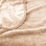 j.elliot home 450gsm solid faux mink blanket natural Soft beige fleece blanket close-up view.