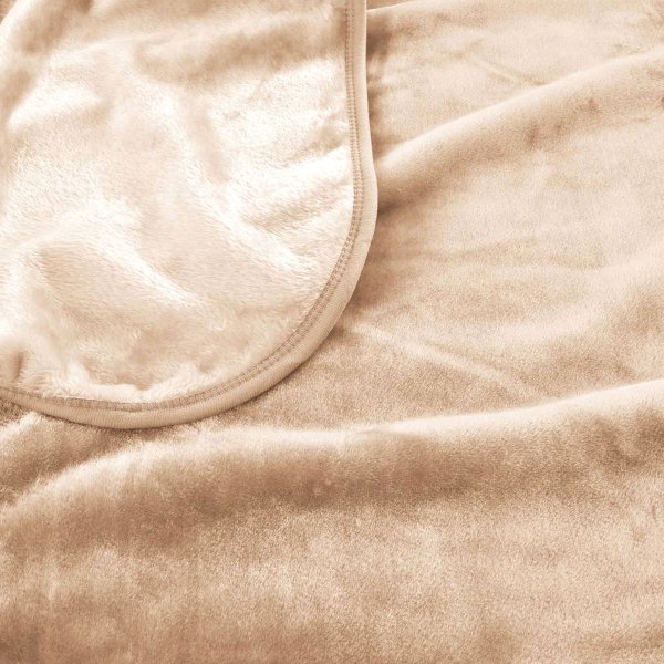 Soft beige fleece blanket close-up view.