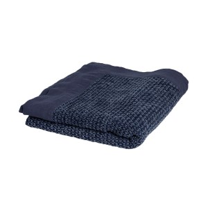 Folded blue textured blanket on white background.