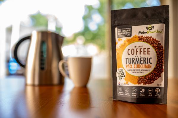 Turmeric coffee pack with kettle and mug.