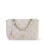 White quilted handbag with gold chain details.