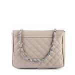 Beige quilted handbag with chain strap.