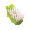 Green and white scrubbing brush for cleaning surfaces.
