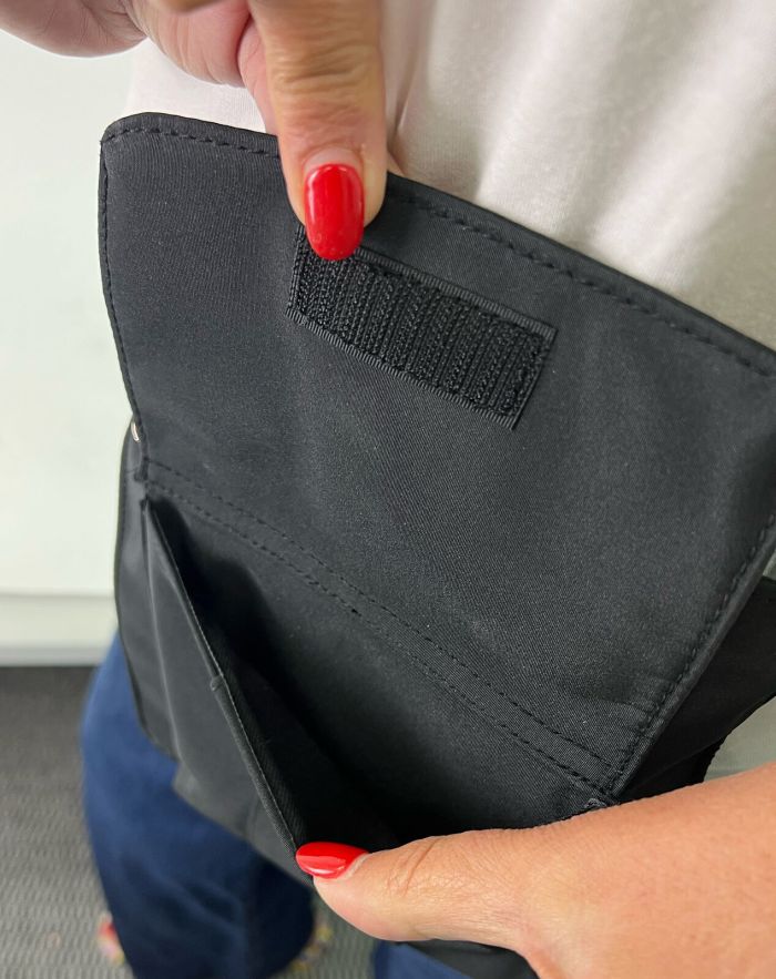 pierre cardin inspired milleni luggage bag large in blue + free milleni waist bag Person holding open black bag with Velcro closure.