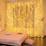 Cosy bedroom with fairy lights and pink decor.