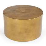 Round brass coffee table with hammered texture.
