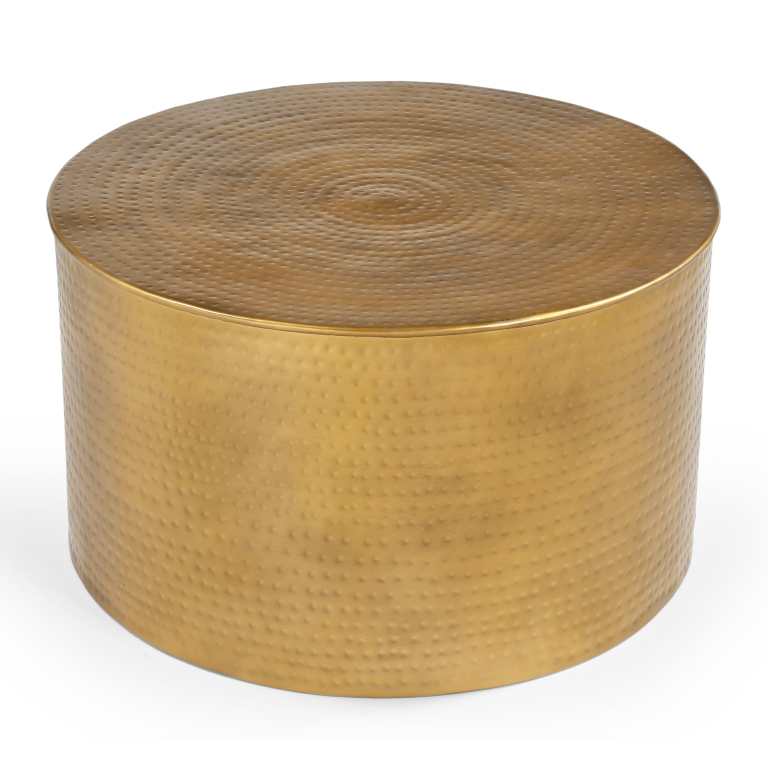 Round brass coffee table with hammered texture.