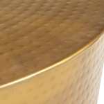 Close-up of round hammered gold tabletop.