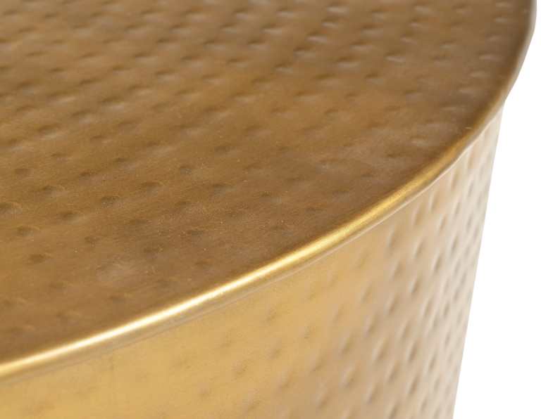 Close-up of round hammered gold tabletop.