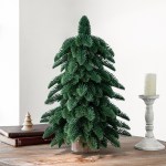 v888 elosung10511 205490 00.jpg Artificial Christmas tree on wooden table