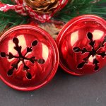 Red Christmas bells with snowflake cutouts.