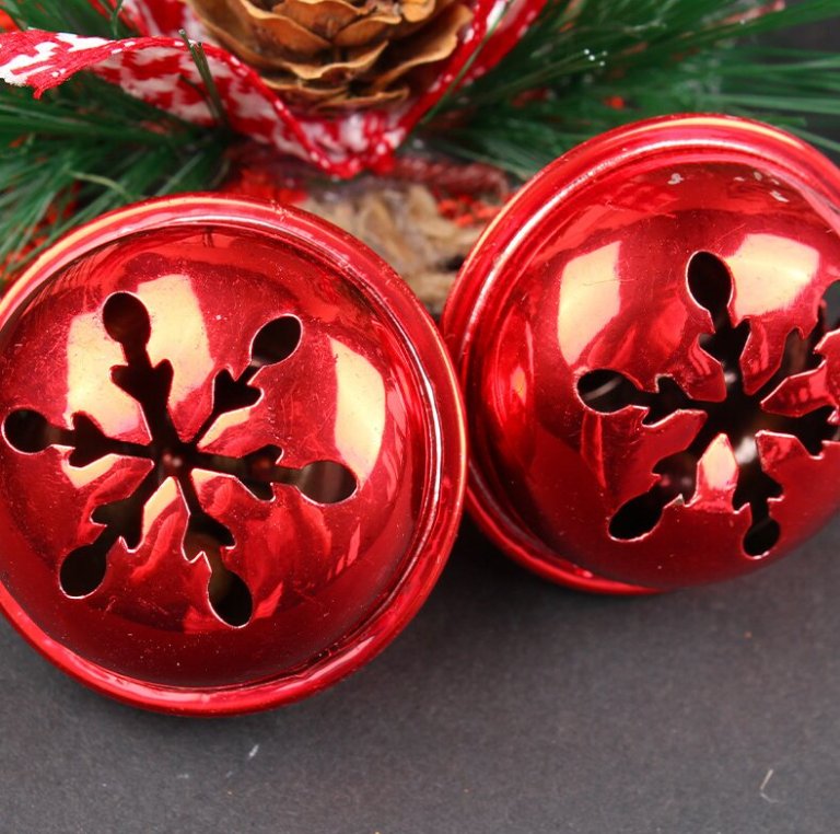 Red Christmas bells with snowflake cutouts.