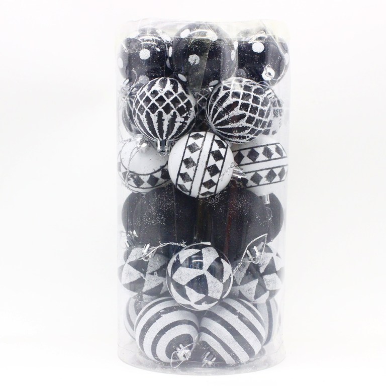 Black and white Christmas baubles in a clear container.