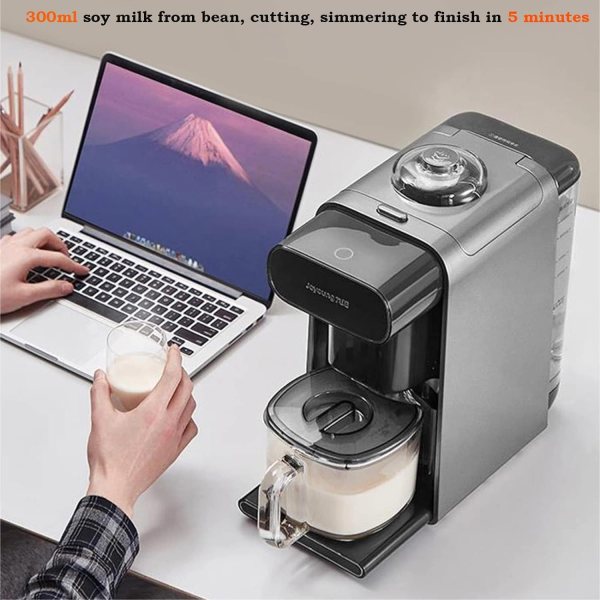 joyoung k1s pro soymilk machine soybean milk coffee maker juicer water dispenser Soy milk maker next to laptop on desk.