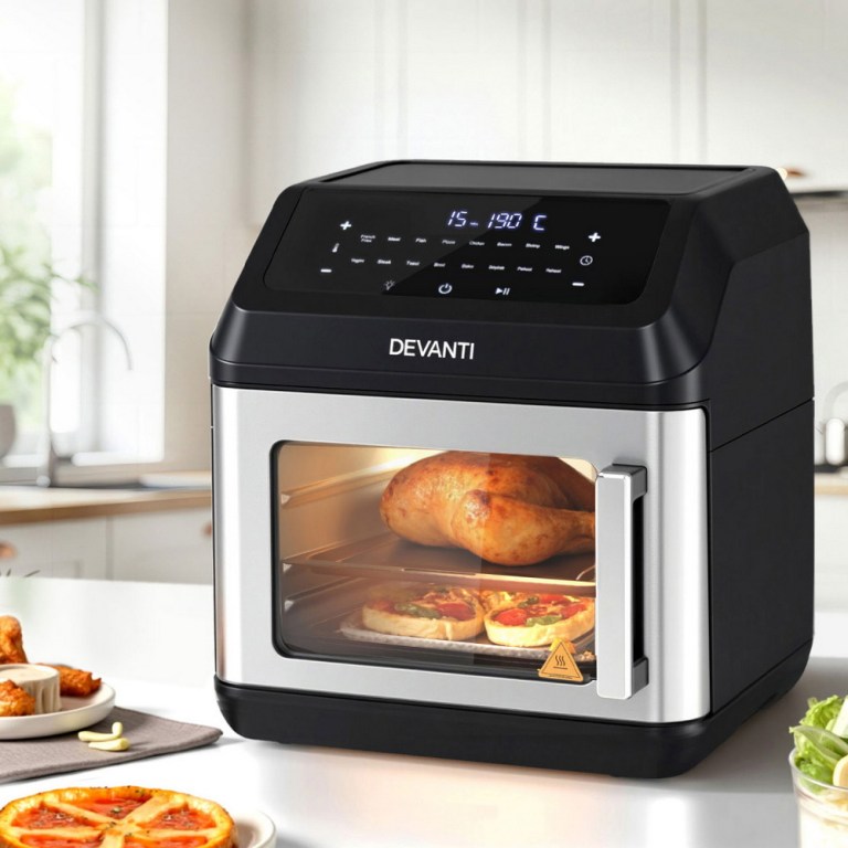 Modern benchtop oven cooking chicken and pizza.