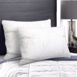 Two white pillows on a neatly made bed.