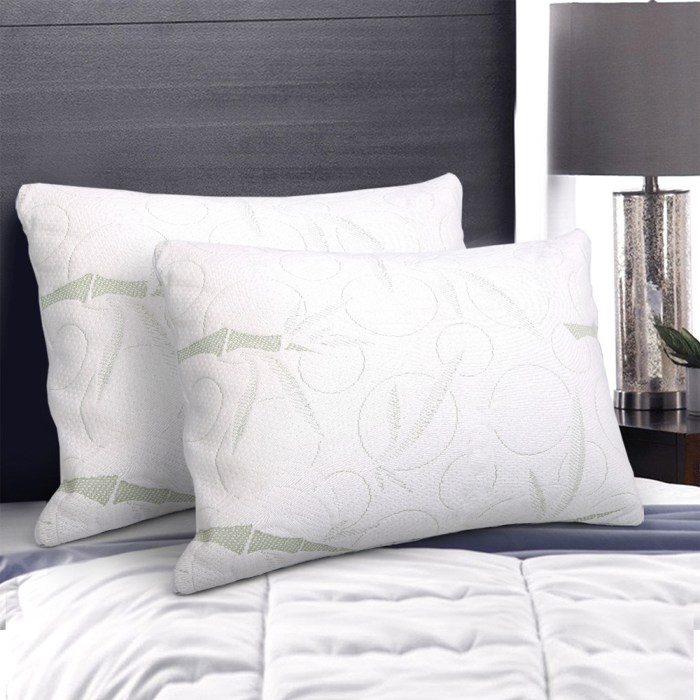 Two white pillows on a neatly made bed.