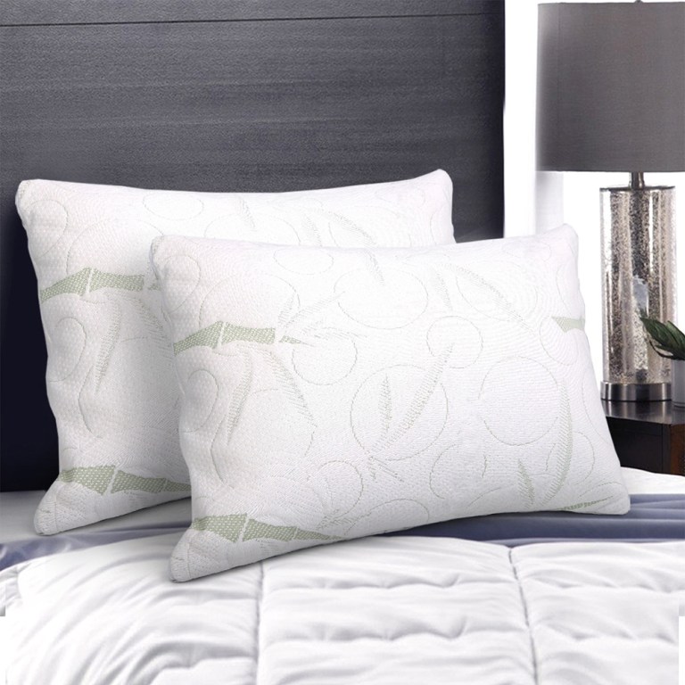 Two white pillows on a neatly made bed.