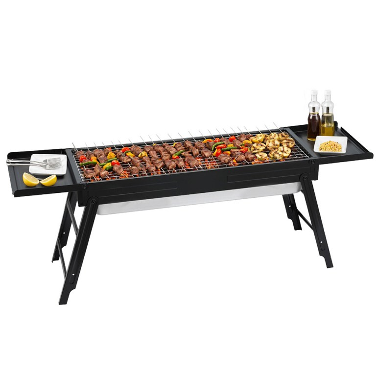 Outdoor barbecue grill with skewers and condiments.