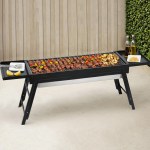 Portable barbecue grill with skewers and condiments.