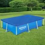 Rectangular above-ground pool with blue cover in garden.