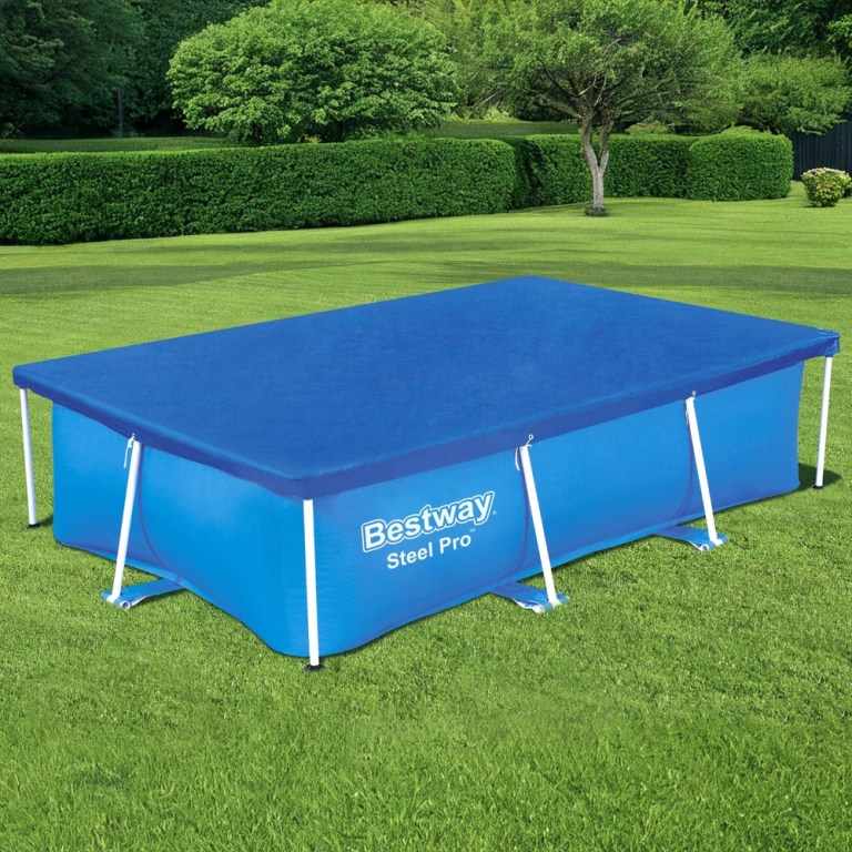 Rectangular above-ground pool with blue cover in garden.