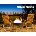 grillz fire pit bowl cast iron rustic 70cm Outdoor fire pit with wooden chairs at sunset.