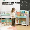 Child accessing books from low shelf.