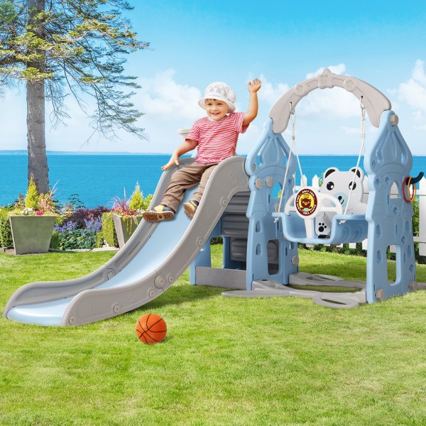 Child sliding on playset by ocean view.
