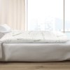 giselle bedding body support pillow bamboo cover Eco-friendly pillow on a white bed.