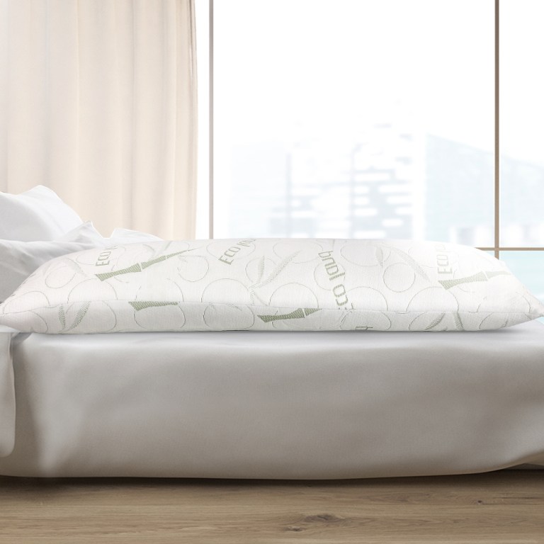 Eco-friendly pillow on a white bed.