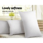 Soft white pillows by sunny window.