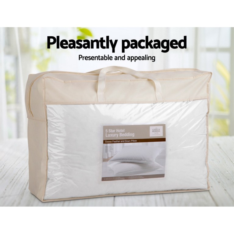 Luxury bedding in transparent packaging on table.