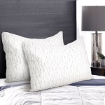 White pillows on a modern bed with lamp.