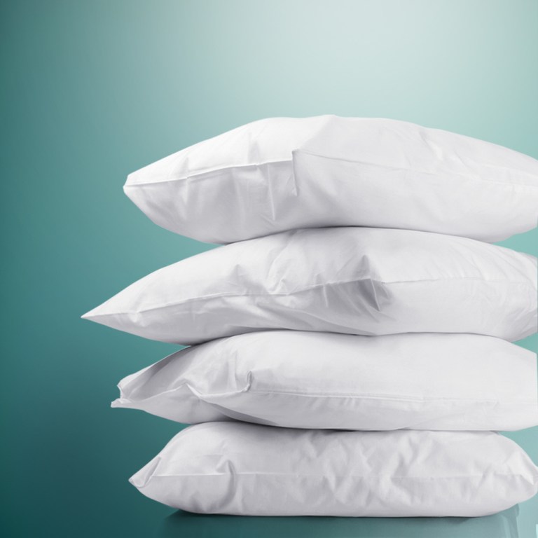 Stack of white pillows against teal background.