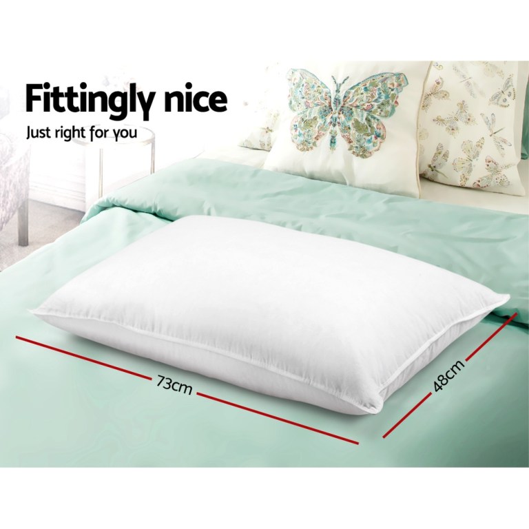 White pillow on bed, butterfly cushions, 73x48cm dimensions.