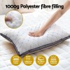 Hand pressing soft polyester fibre pillow.