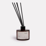 Honeysuckle bushflower diffuser in dark glass bottle.