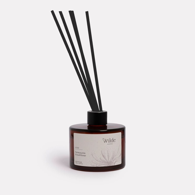 Honeysuckle bushflower diffuser in dark glass bottle.