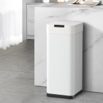Automatic kitchen bin next to counter.