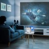 Person watching football on projector at home.