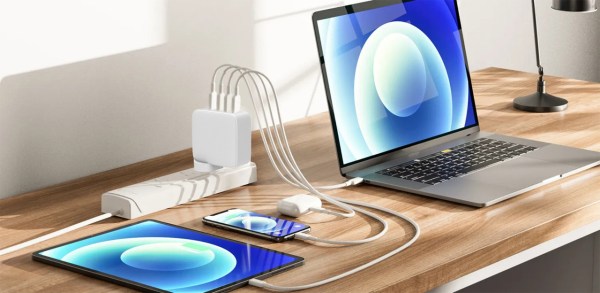 Laptop, tablet, phone charging on a desk