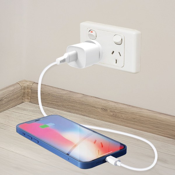 laser usb a 18w qc3 wall charger white Phone charging with wall adapter on corner shelf.