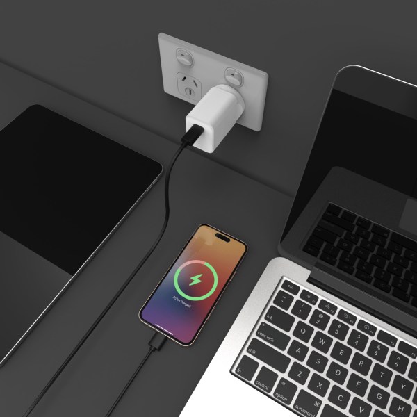 laser chargecore 45w pd gan usb c wall charger Smartphone charging on desk near laptop and power outlet.