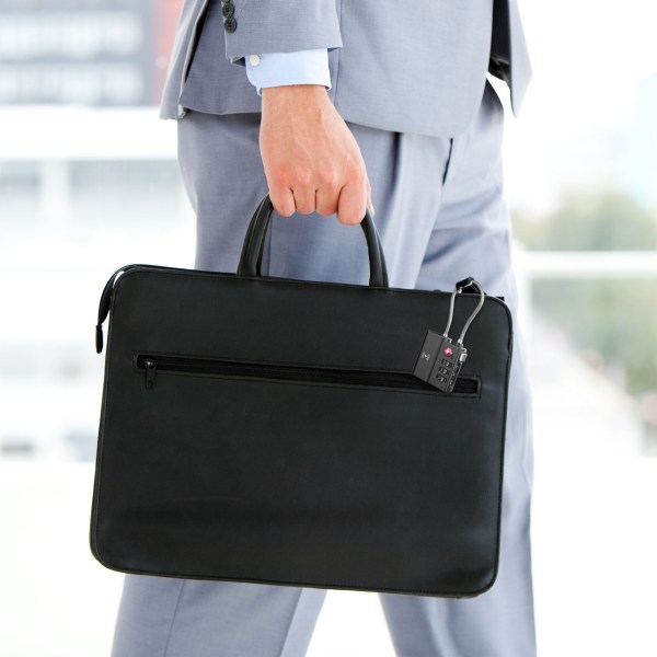 laser tsa lock smart tag with rechargeable battery black Person in suit carrying black briefcase.