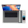 Laptop with phone and wireless charger on desk